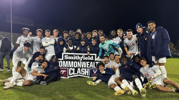 The Virginia men's soccer team celebrates after defeating Virginia Tech in Blacksburg.
